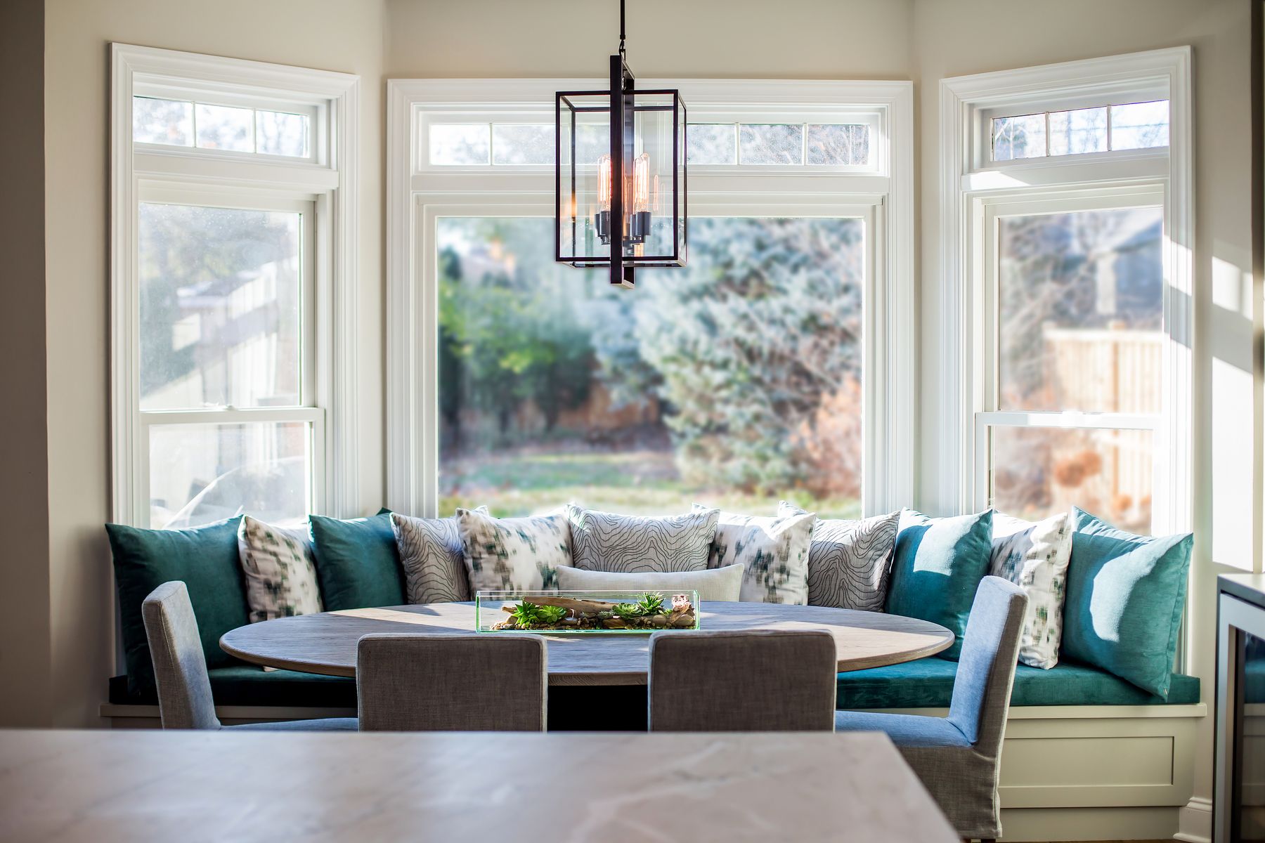 Kitchen island with pendant lighting and brass hardware