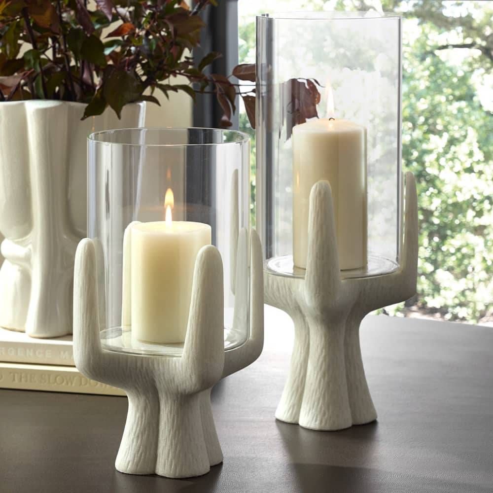 Sculptural white candle holders with glass hurricanes