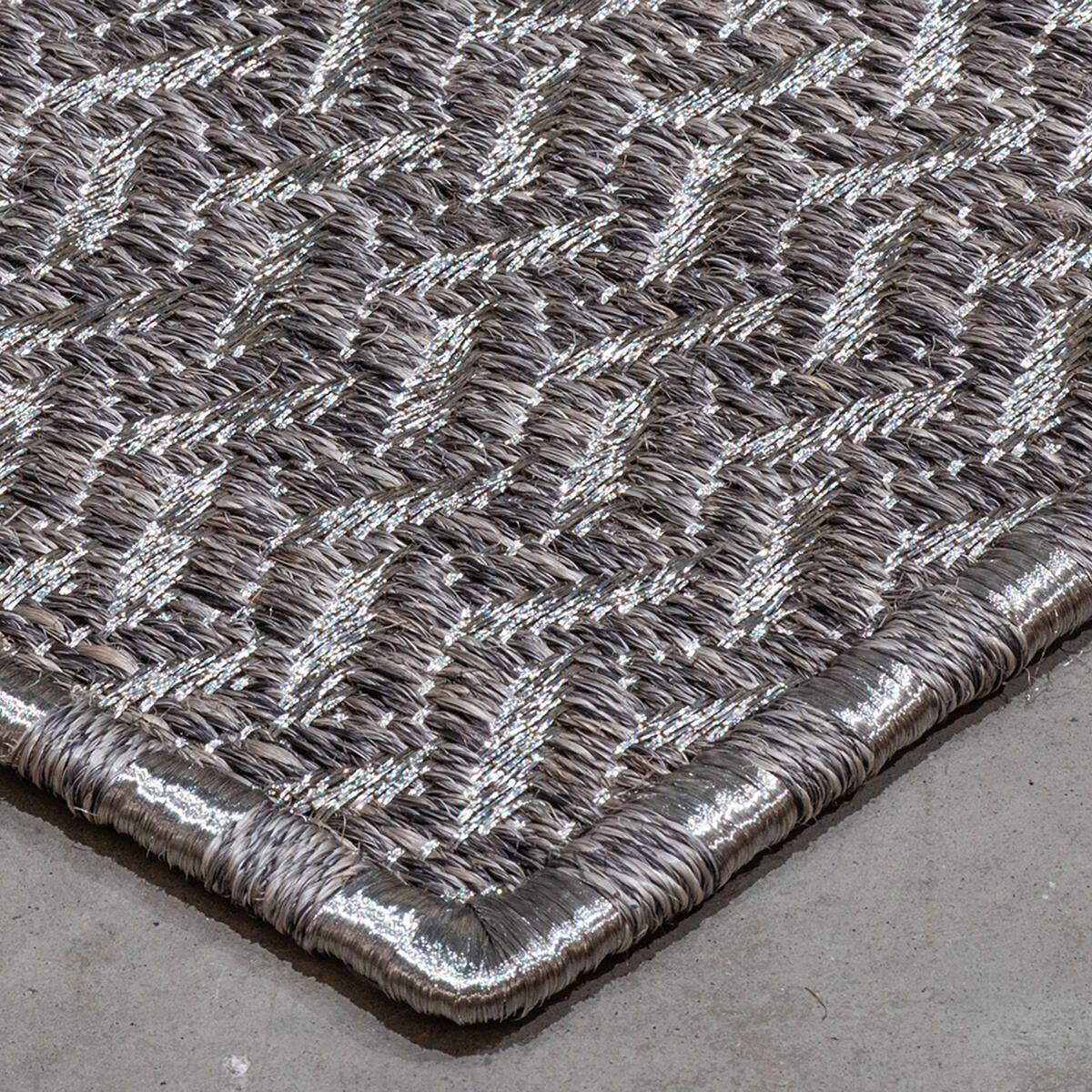 Woven rug with metallic silver accents